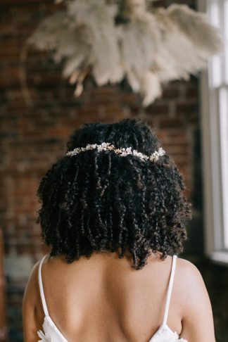 gold and pearl headband on bride