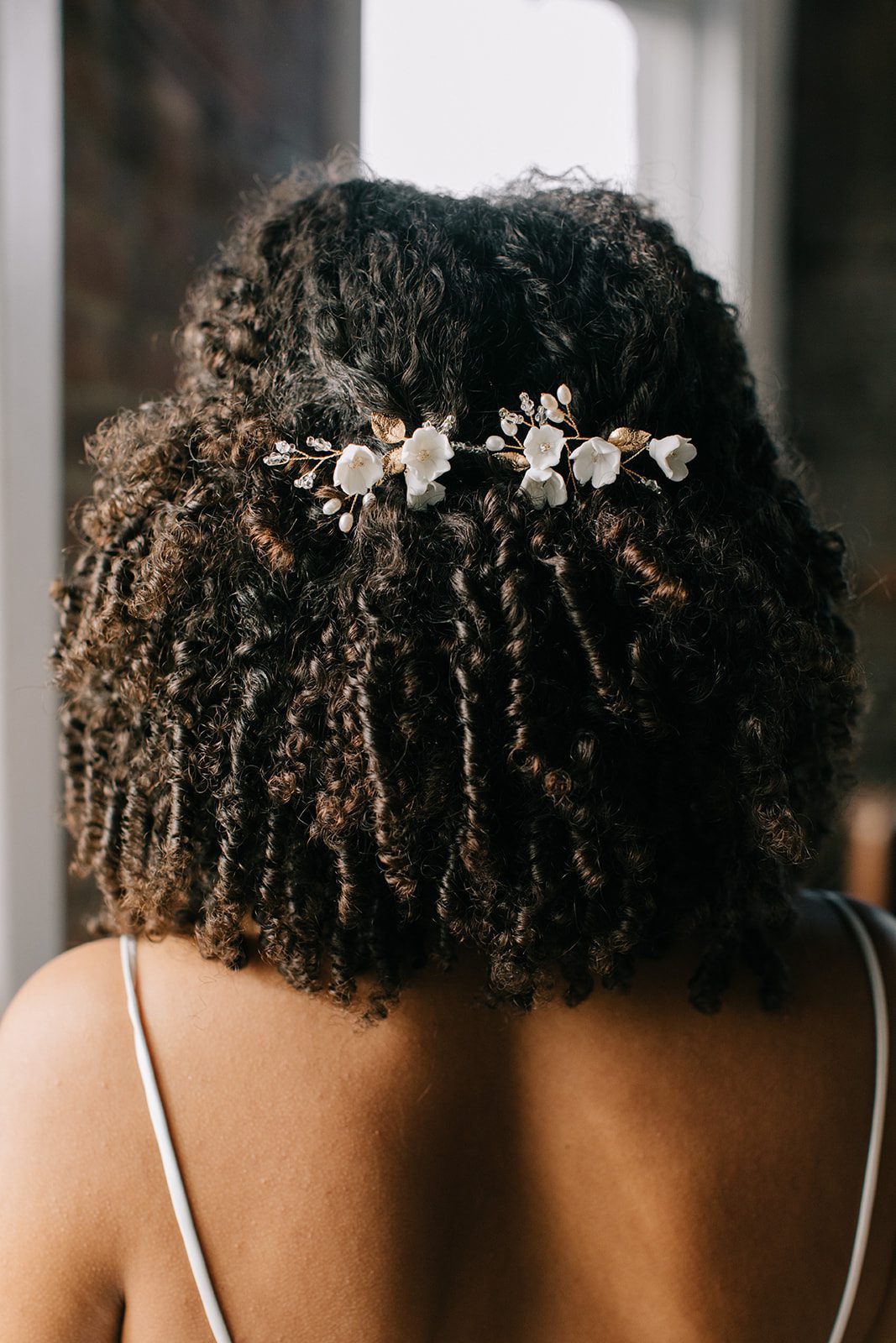gold floral hair pins on bride