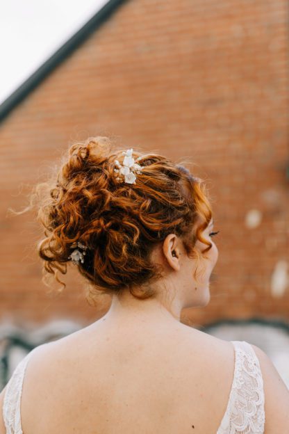 gold floral hair pins on bride updo